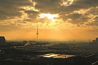 Sonne strahlt gelb durch Wolkenloch in Bremen, Großmarkt und Funkturm