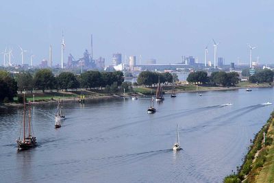 Motorboote und Segelschiffe auf der Weser, Windräder und Industrieanlagen